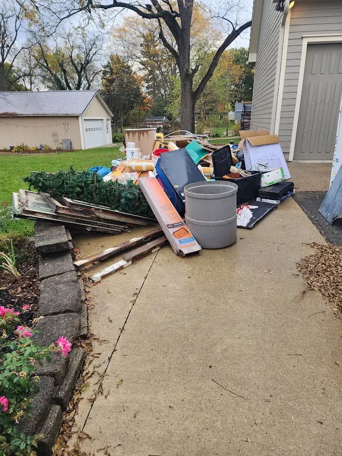 Dumpster being loaded with debris for 10 Yard Dumpster Rental in Sturgis